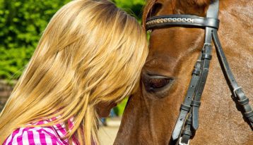 Equine-Assisted Psychotherapy (EAP) , Equine-Assisted Psychotherapy, blonde woman with head pressed against horse's forehead