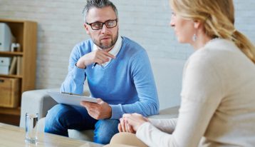 Therapy During Recovery, individual therapy - woman talking to male therapist
