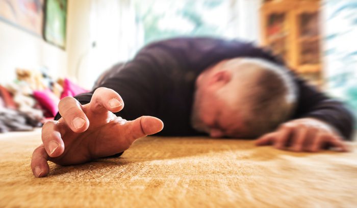 man on floor at home sick seizure