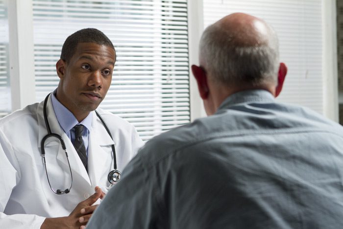 african american doctor speaking to his patient