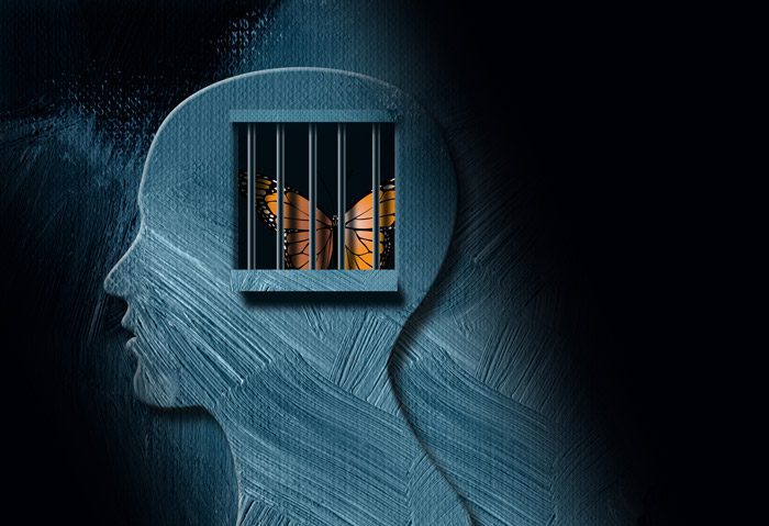 illustration of monarch butterfly trapped in cage of human head silhouette - trauma